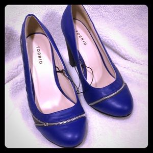 Blue and black heels with zipper detail.